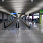 Modern airport terminal moving walkway — EU Entry Exit System guide for British second-home owners in Spain
