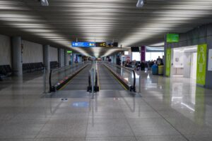 Modern airport terminal moving walkway — EU Entry Exit System guide for British second-home owners in Spain