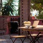 Person working on a laptop outdoors at a rustic table, representing the digital nomad lifestyle in Spain