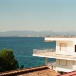 White Mediterranean building overlooking turquoise coastline — Spain Non-Lucrative Visa for British retirees