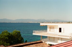 White Mediterranean building overlooking turquoise coastline — Spain Non-Lucrative Visa for British retirees