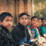 Children in school uniform sitting outdoors — international school on the Costa del Sol