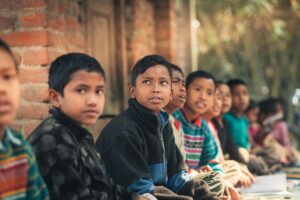 Children in school uniform sitting outdoors — international school on the Costa del Sol