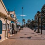 Beachfront promenade restaurant on the Costa del Sol — comparing cost of living in Spain vs the UK