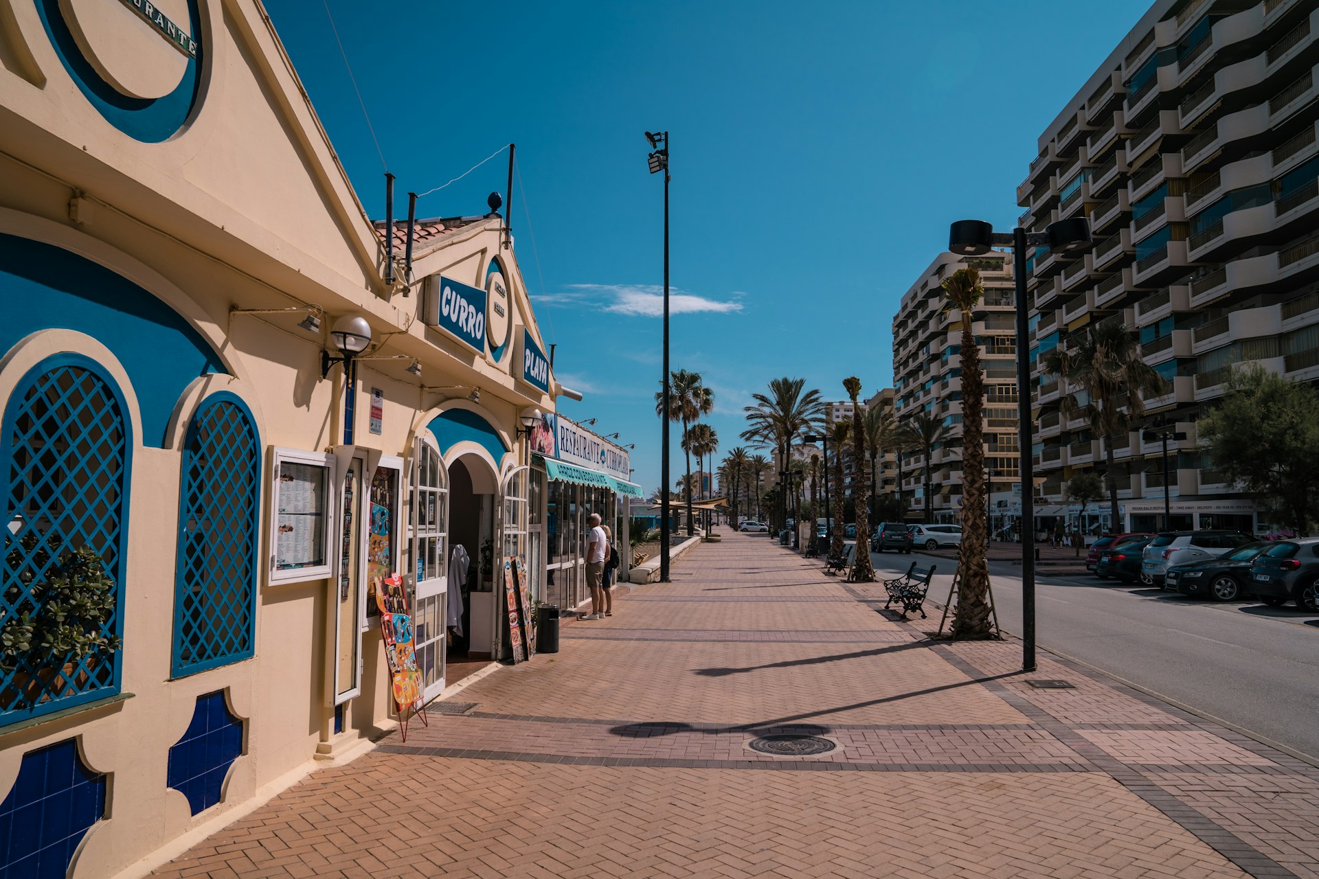Beachfront promenade restaurant on the Costa del Sol — comparing cost of living in Spain vs the UK