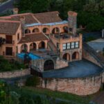 Luxury villa with swimming pool on a hillside in Spain, representing property ownership and sale on the Costa del Sol