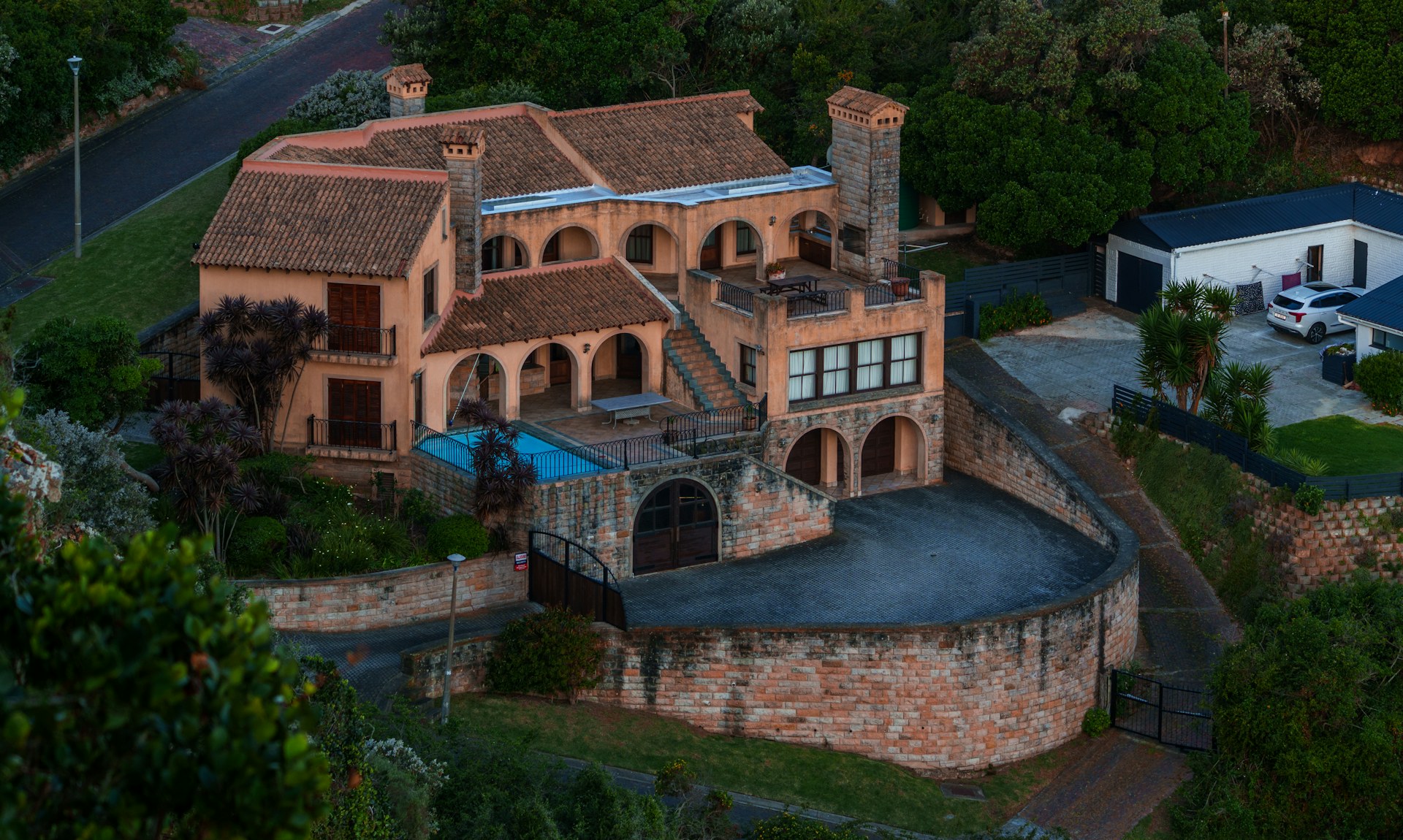 Luxury villa with swimming pool on a hillside in Spain, representing property ownership and sale on the Costa del Sol