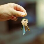 Hand holding house keys at a Spanish property purchase in 2026, representing the contrato de arras process