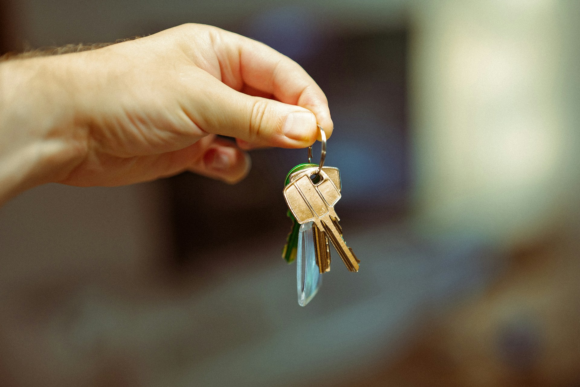 Hand holding house keys at a Spanish property purchase in 2026, representing the contrato de arras process