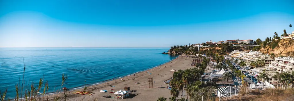 Playa Burina beach in Nerja with apartments overlooking the sea