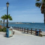 Sunny beach promenade with palm trees on the Costa del Sol in winter