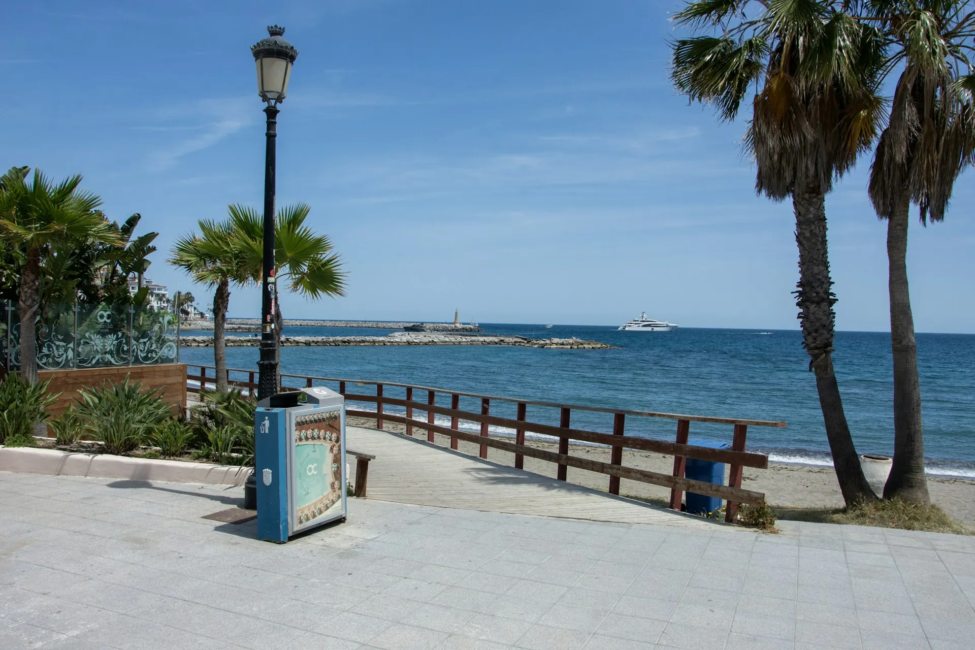 Sunny beach promenade with palm trees on the Costa del Sol in winter