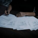 Woman signing a legal document at a desk — Power of Attorney for buying property in Spain as a British buyer