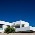 Modern white Spanish villa with clear blue sky — property survey and due diligence guide for British buyers