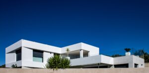 Modern white Spanish villa with clear blue sky — property survey and due diligence guide for British buyers