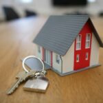 House model and keys on a desk — completion day and signing the escritura when buying property in Spain