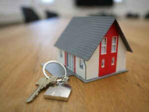 House model and keys on a desk — completion day and signing the escritura when buying property in Spain