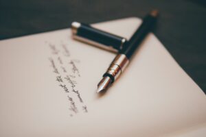 Fountain pen resting on cream stationery, ready to sign a Spanish will for a British property owner