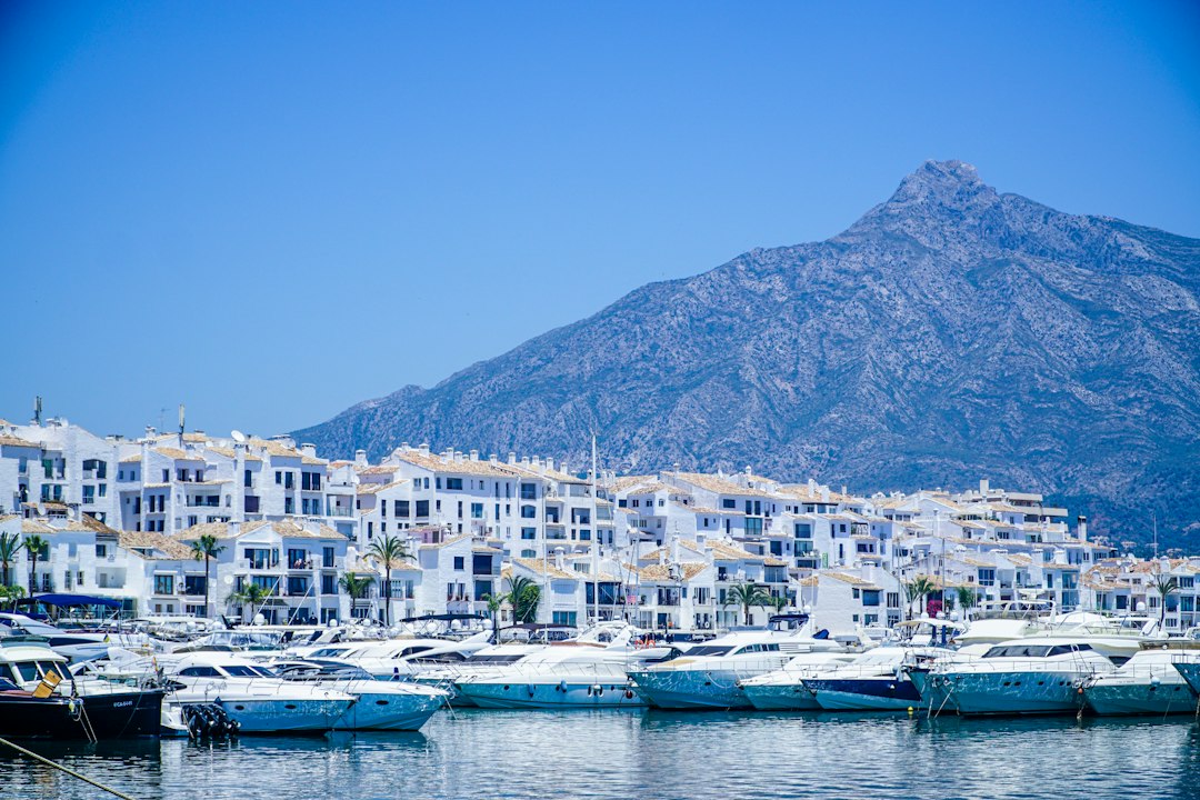 Puerto de la Duquesa marina with boats moored and waterfront promenade, Manilva, Costa del Sol, Spain
