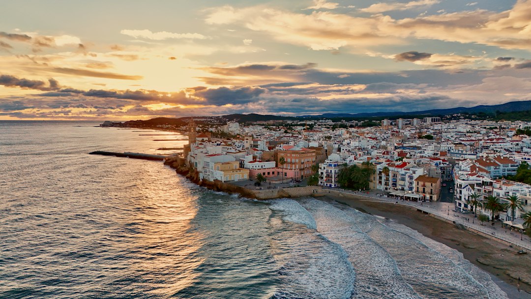 Aerial view of a Spanish coastal town at sunset with sandy beaches and the Mediterranean Sea